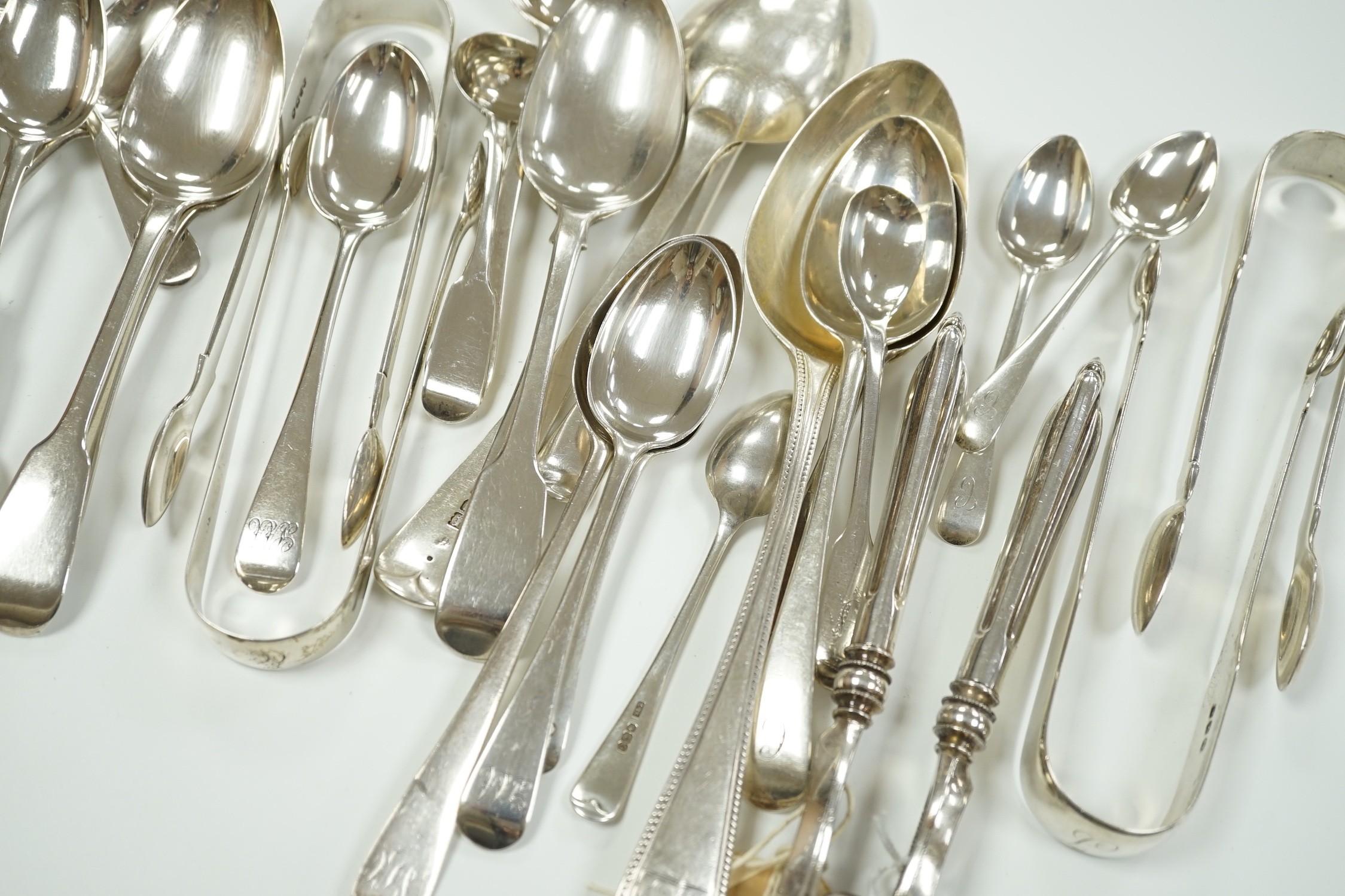 A quantity of assorted mainly 19th century silver flatware, various patterns, dates and makers, including a cased set of six 1937 Coronation silver teaspoons, four pairs of Georgian sugar tongs and a pair of Edwardian si